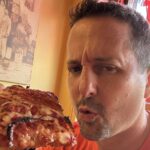 Matt Plapp of America's Best Restaurants eats a slice of pizza