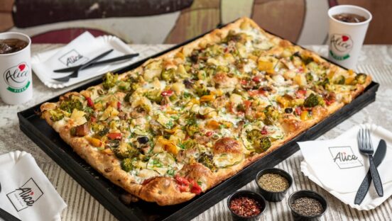 This photo shows a Roman-style pizza topped with