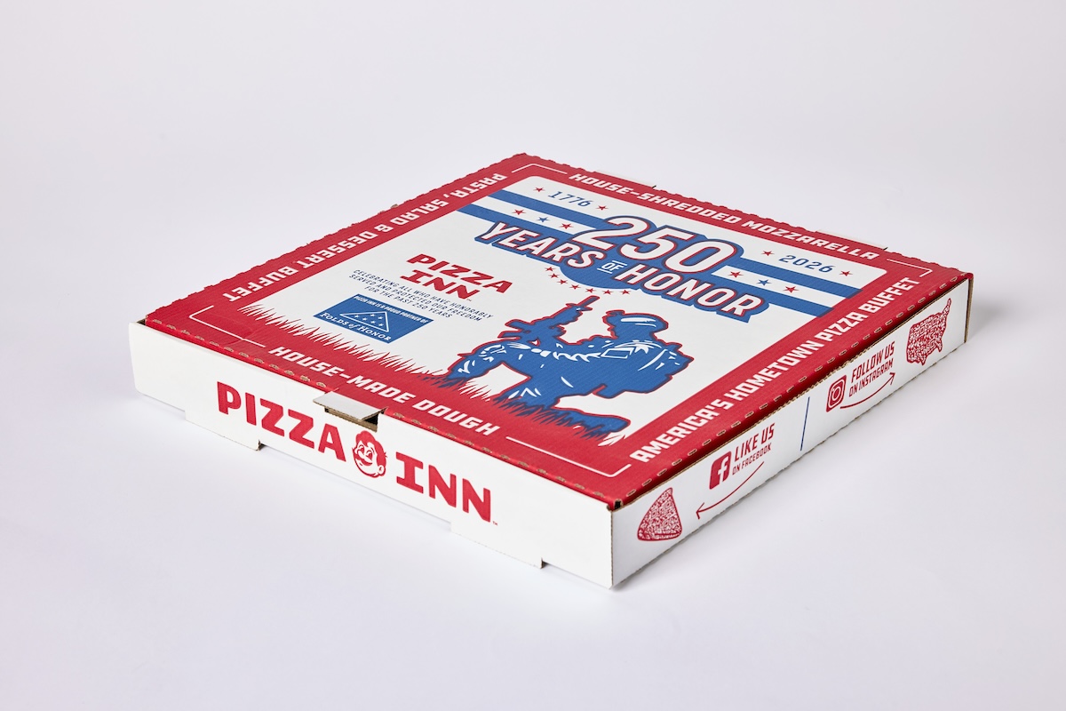 This photo shows Pizza Inn's limited-edition pizza box. The colors are red, white and blue. The key graphics include a banner at the top that reads "250 Years of Honor." Beneath that is a silhouette of a soldier kneeling in grass and holding up a machine gun.