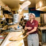 Gerardo Moceri Jr. tosses a dough for pizza at Gerardo's Pizzeria in Sedona, Arizona