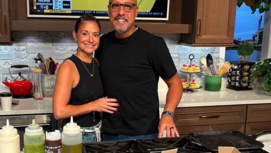 This photo shows Sean Jefairjian and his wife Jessica smiling and standing closely together in their home kitchen.