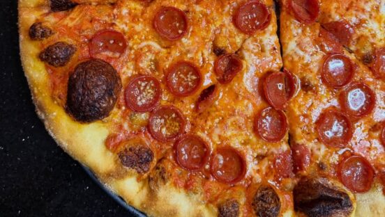This photo shows a close-up of a pepperoni pizza.