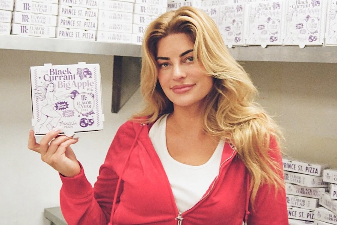 This photo shows Hannah Stockington holding a pizza box for the Black Currant Apple Pie pizza.