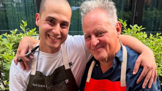 This photo shows pizzeria owner Luis Perez with his arms around the legendary Chris Bianco, both smiling for the camera.