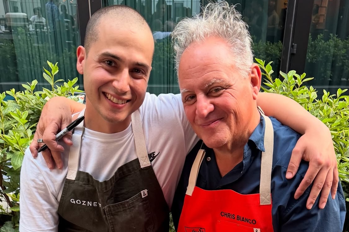 This photo shows pizzeria owner Luis Perez with his arms around the legendary Chris Bianco, both smiling for the camera.