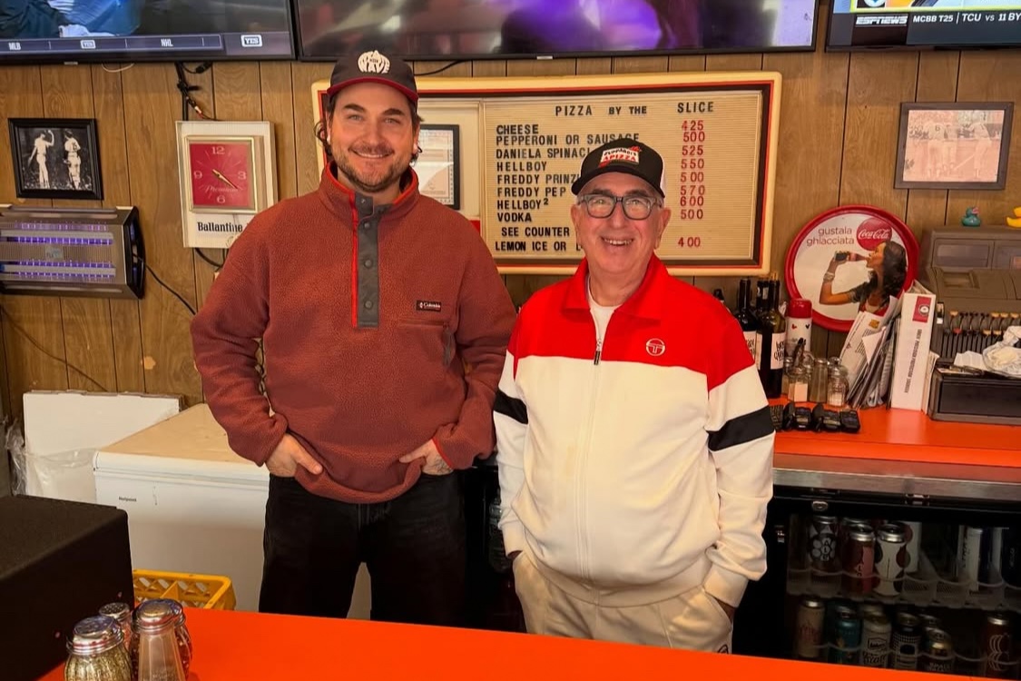 This photo shows Alex Koons and Paul Giannone standing side by side behind the counter at Paulie Gee's in New York.