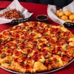 This photo shows the Dr Pepper BBQ Pizza along with the tater tots and wings described in the story.