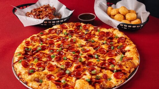 This photo shows the Dr Pepper BBQ Pizza along with the tater tots and wings described in the story.