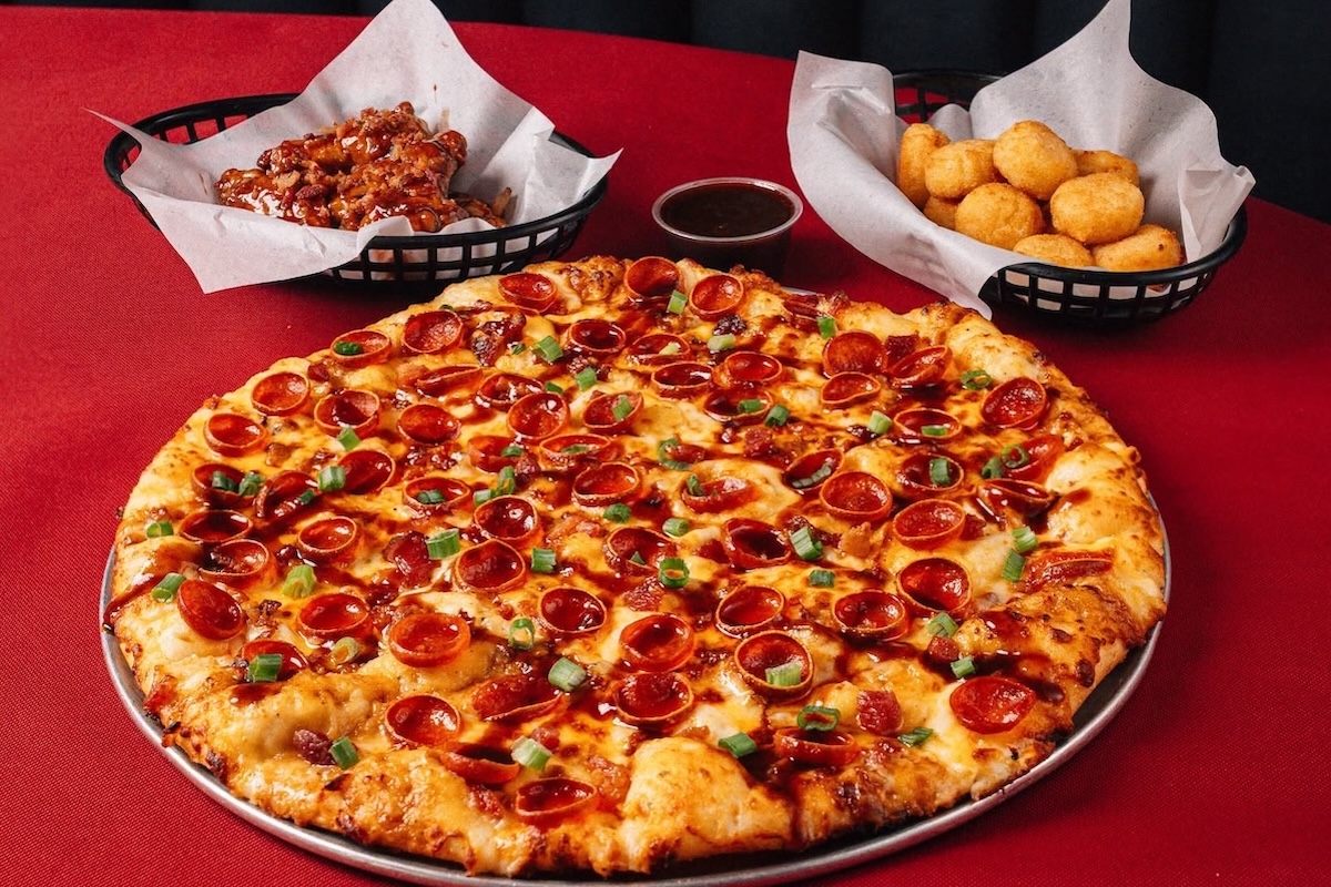 This photo shows the Dr Pepper BBQ Pizza along with the tater tots and wings described in the story.
