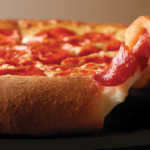 This photo shows a bit of cheese oozing out of the crust of Papa Johns Epic Pepperoni Stuffed Crust pizza.