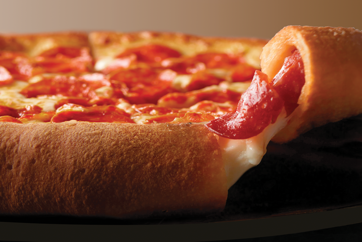 This photo shows a bit of cheese oozing out of the crust of Papa Johns Epic Pepperoni Stuffed Crust pizza.
