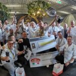 This photo shows a group of competitors, some of them holding trophies, celebrating happily at last year's Pizza Champion Cup in Sweden.