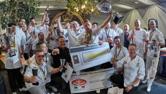 This photo shows a group of competitors, some of them holding trophies, celebrating happily at last year's Pizza Champion Cup in Sweden.