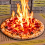 This photo shows a pepperoni pizza emitting flames from the top to illustrate the Reaper Roulette pizza described in the story.