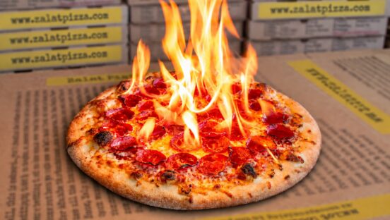 This photo shows a pepperoni pizza emitting flames from the top to illustrate the Reaper Roulette pizza described in the story.