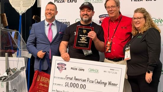 This photo shows Giovanni Labbate with Pizza Exp officials. He is holding a giant check for $1,000.