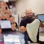 Darius T. Aram, owner and founder of Slice Street Pizza in Dripping Springs, Texas, stretches a dough