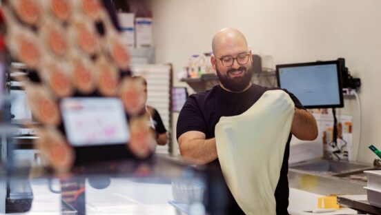 Darius T. Aram, owner and founder of Slice Street Pizza in Dripping Springs, Texas, stretches a dough